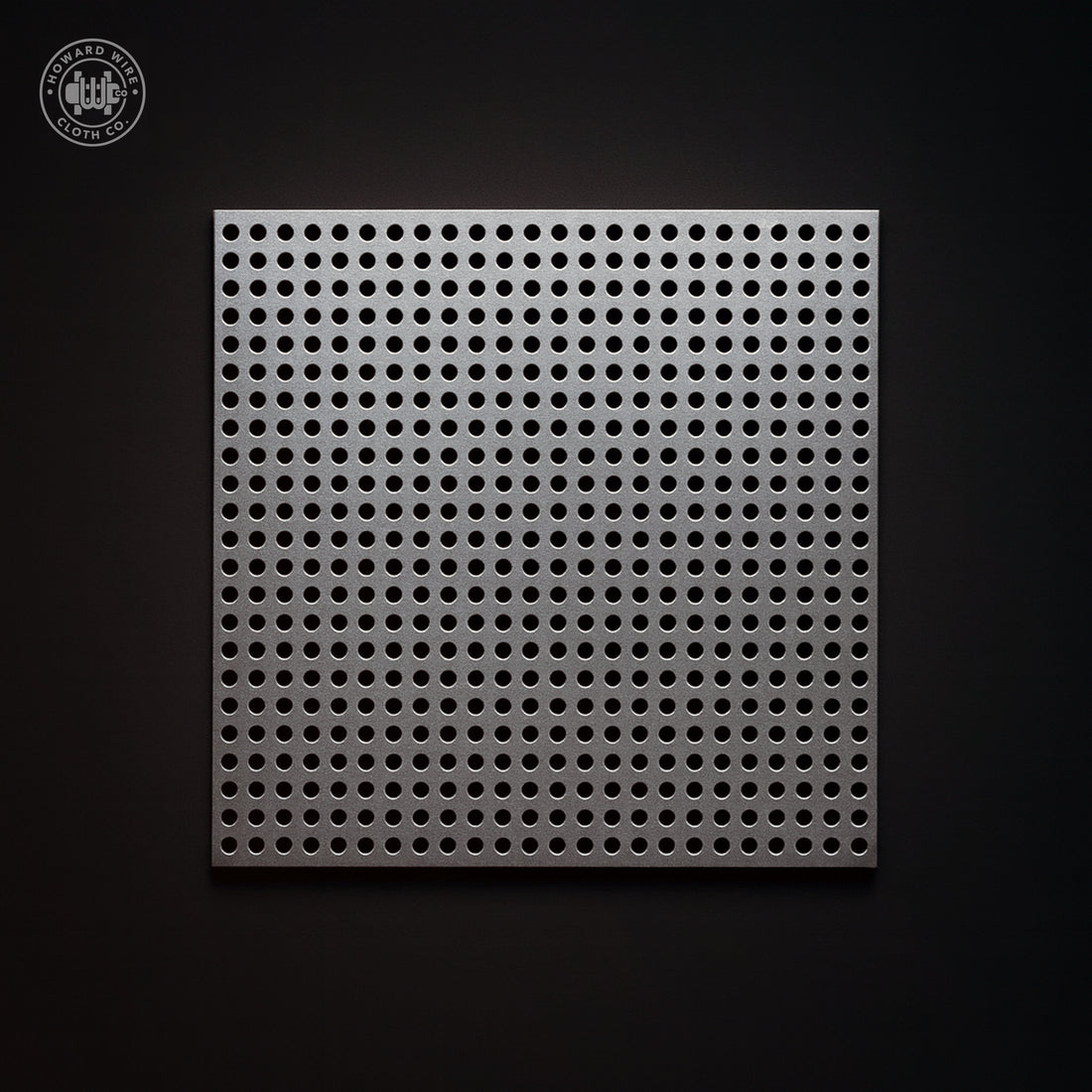 Studio product photograph of aluminium perforated sheet, .050 inch round holes on .066 inch straight centres, .032 inch thick, on a dark graphite background.