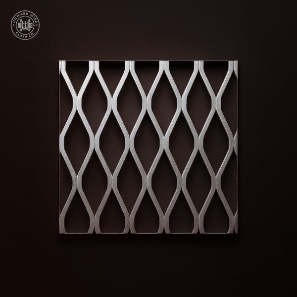 Studio product photograph of aluminium flattened expanded metal, 1-1/2 inch .125, showing diamond openings, on a dark graphite background.